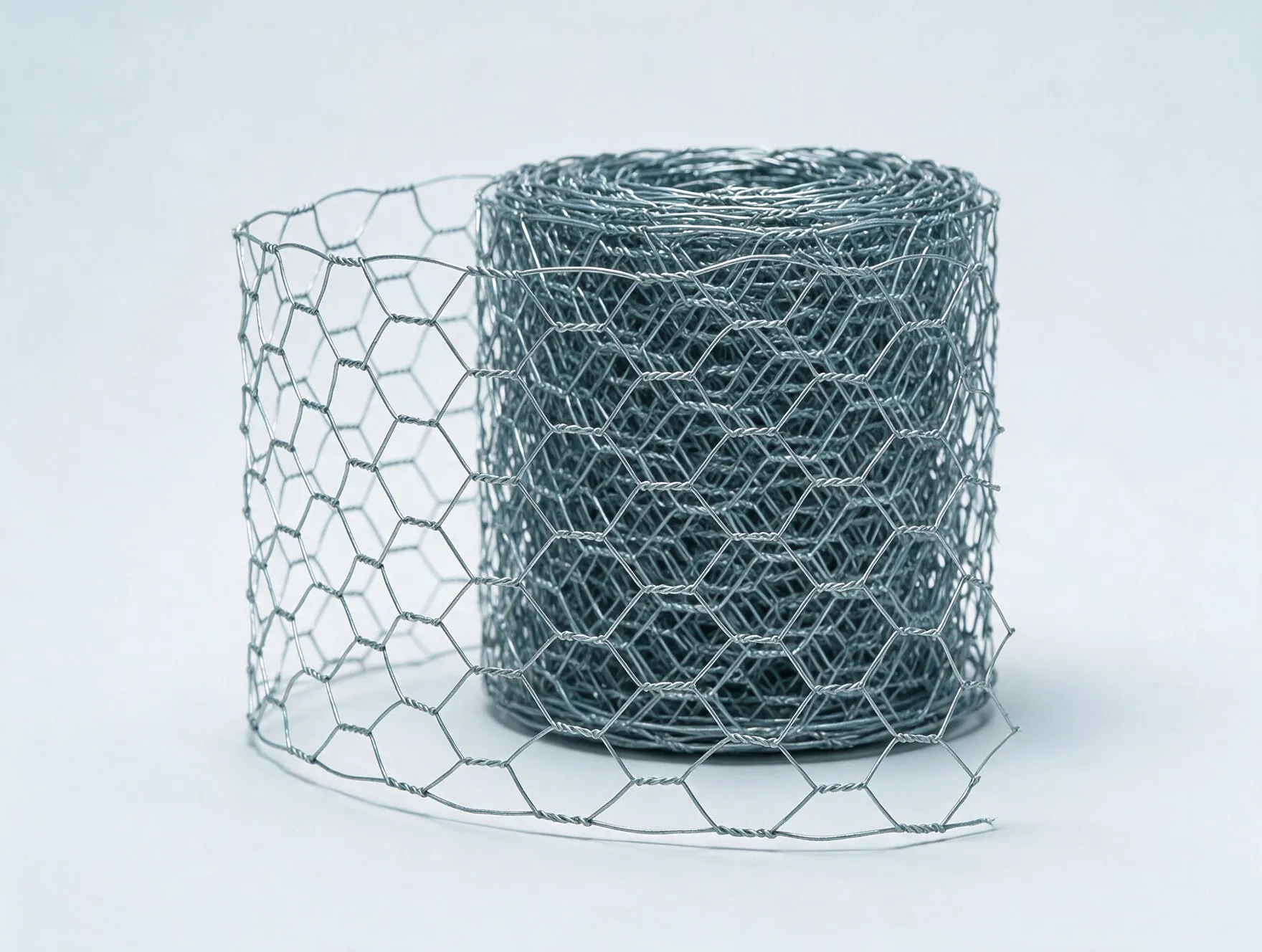 A roll of galvanised hexagonal wire mesh, partly unrolled