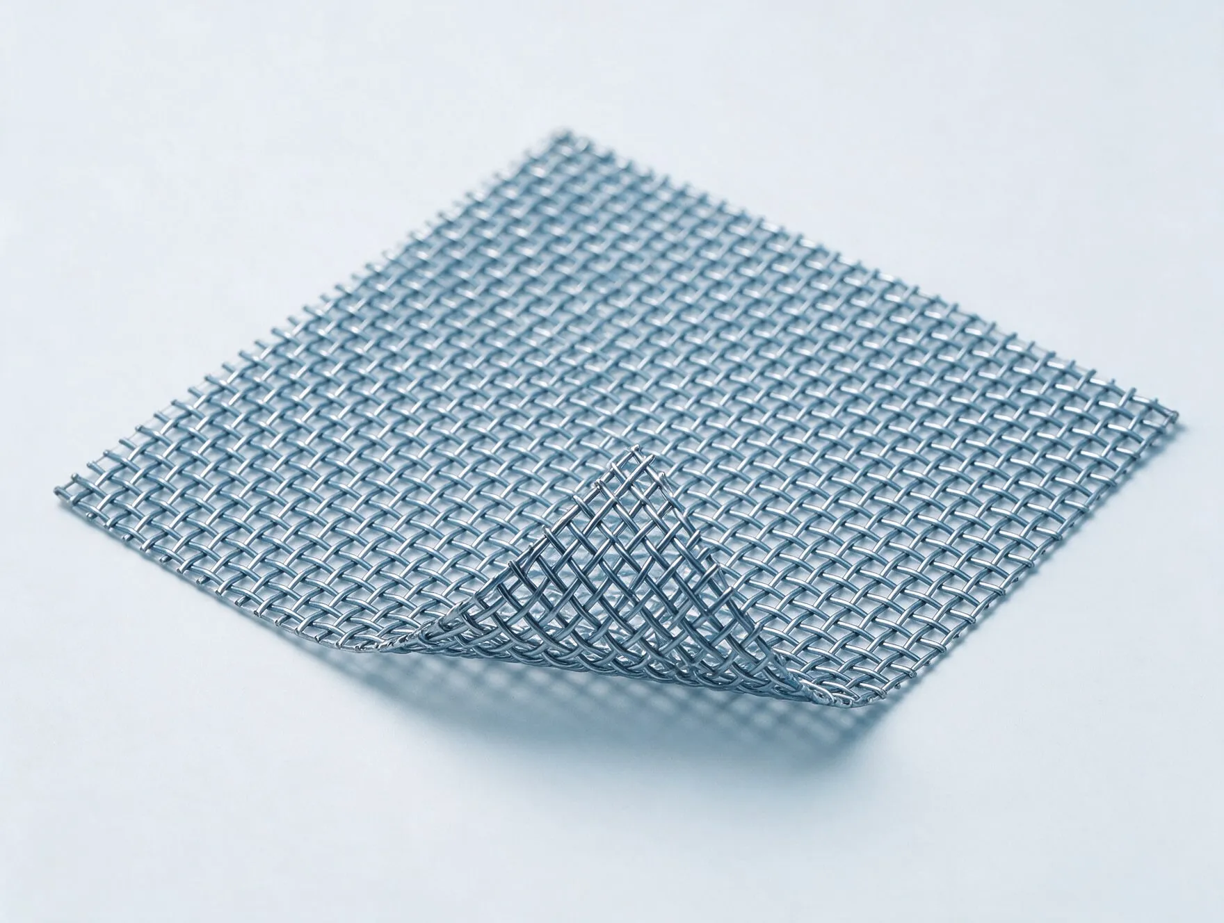 A sheet of woven stainless steel wire mesh with one corner lifted