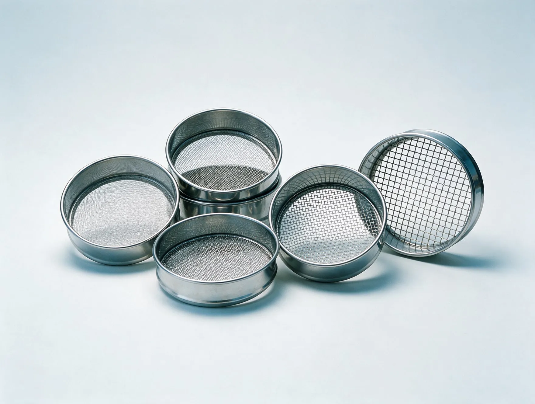 A set of round stainless steel sifter sieves in different mesh sizes