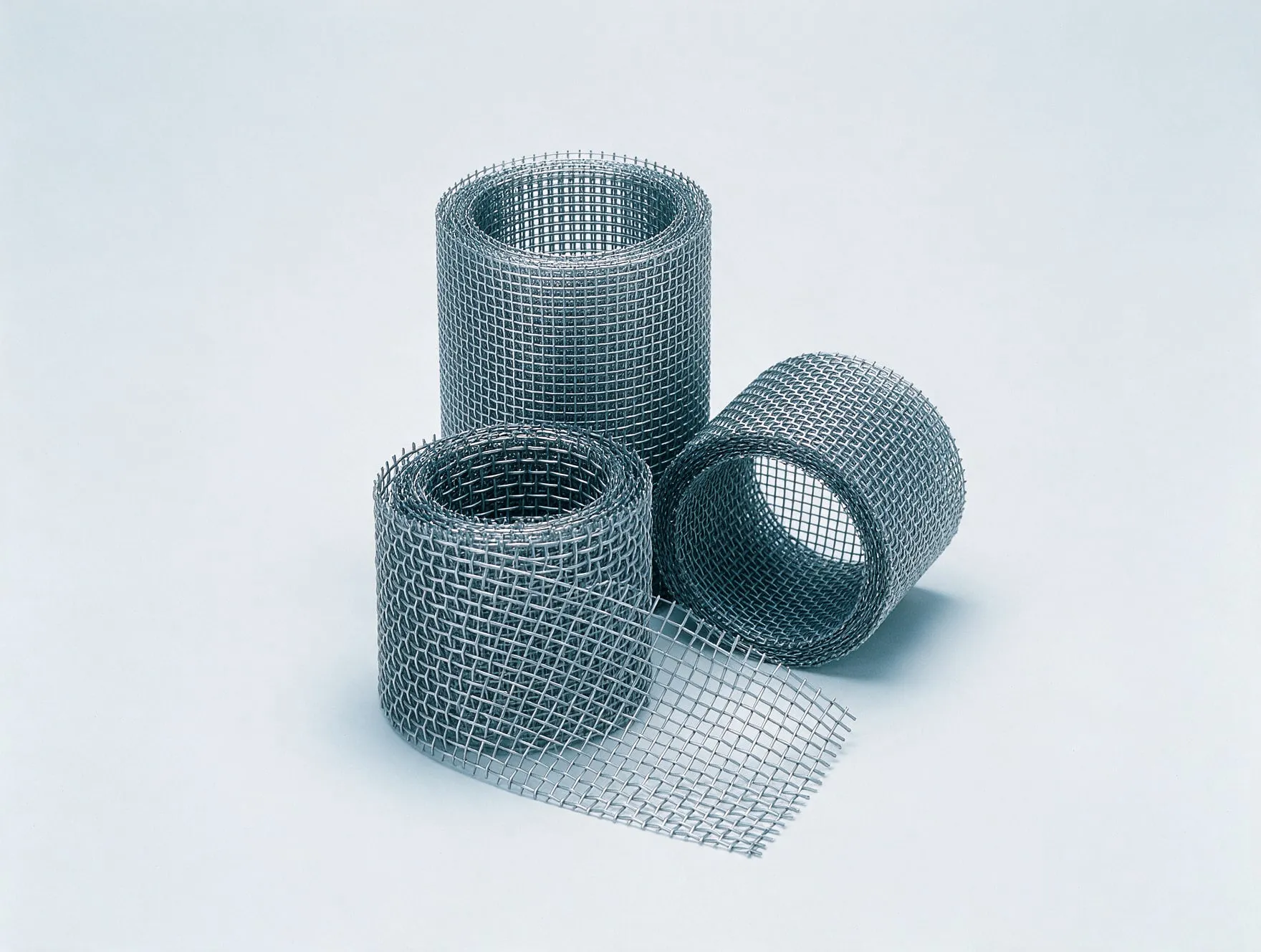 Three rolls of woven stainless steel wire mesh in different mesh sizes