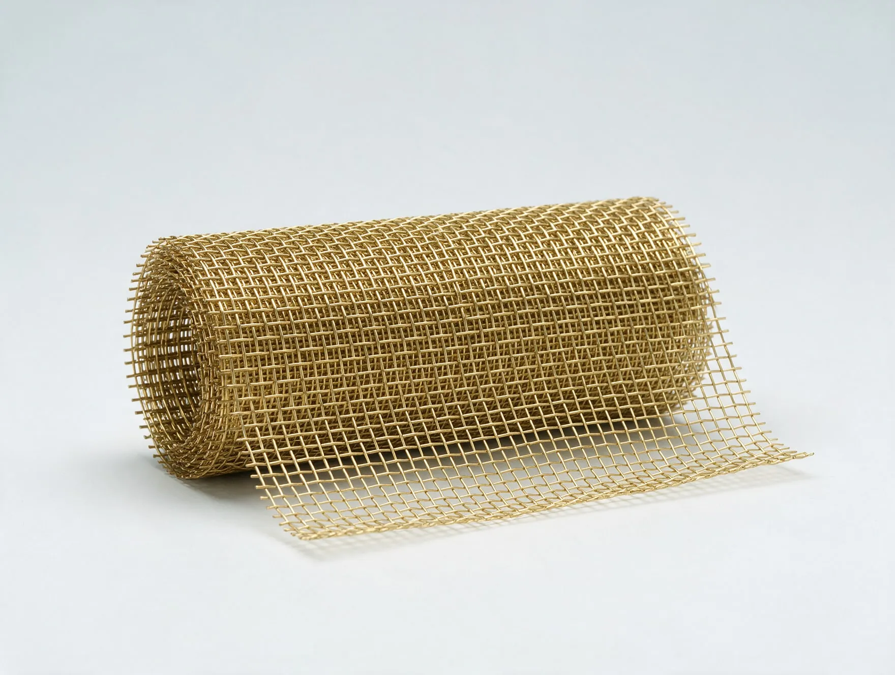 A roll of woven brass wire mesh, partly unrolled