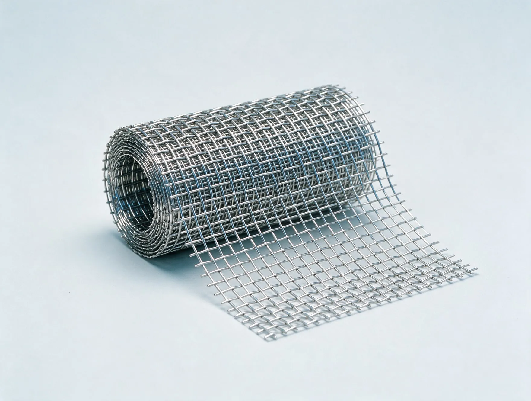 A roll of woven stainless steel wire mesh, partly unrolled